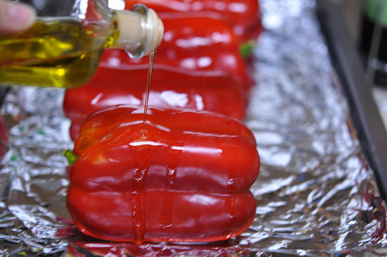 Clean the bell peppers and remove any stickers. Pat the peppers dry. Preheat the oven to 450°F. Cover a cookie sheet with foil and drizzle olive oil over the red peppers.
Clean the bell peppers and remove any stickers. Pat the peppers dry. Preheat the oven to 450°F. Cover a cookie sheet with foil and drizzle olive oil over the red peppers.