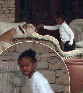 Zahara Jolie-Pitt was spotted giving the family bulldog a bone in the backyard of the family home in Budapest