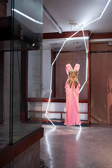 Pale Pink and Bright Pink Silk Georgette and Silk Chiffon Pleated and Draped Gown with hand beaded Swarovski Crystal Elements Tassels with Gold Pleated Metal and Ray Breast Plate Pale Pink and Bright Pink Silk Georgette and Silk Chiffon Pleated and Draped Gown with hand beaded Swarovski Crystal Elements Tassels with Gold Pleated Metal and Ray Breast Plate