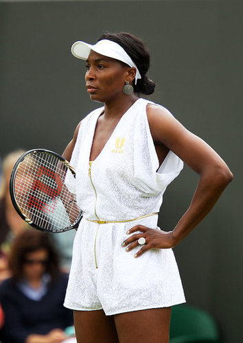 Redeeming herself in 2011 at the Wimbledon Open, Venus wore a classy white and gold flecked romper with a gold zipper and thin gold belt with loose sleeves and a diamond cut out in the back.
Redeeming herself in 2011 at the Wimbledon Open, Venus wore a classy white and gold flecked romper with a gold zipper and thin gold belt with loose sleeves and a diamond cut out in the back.