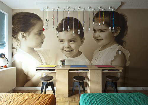To celebrate the triplets, the Novogratzes had a photographer take candid portraits of the kids. The images were then converted into wallpaper by Duggal, a digital printing firm. The dangling NUD light fixtures add some unique and kid-friendly light to the room.
To celebrate the triplets, the Novogratzes had a photographer take candid portraits of the kids. The images were then converted into wallpaper by Duggal, a digital printing firm. The dangling NUD light fixtures add some unique and kid-friendly light to the room.