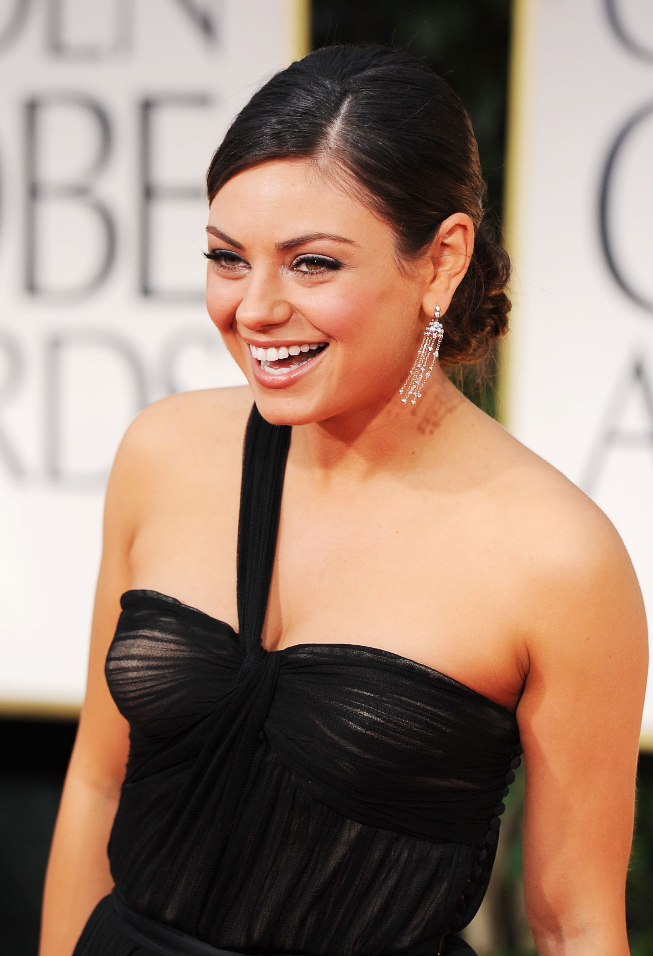 Mila Kunis in black at the Golden Globes. Mila Kunis in black at the Golden Globes.