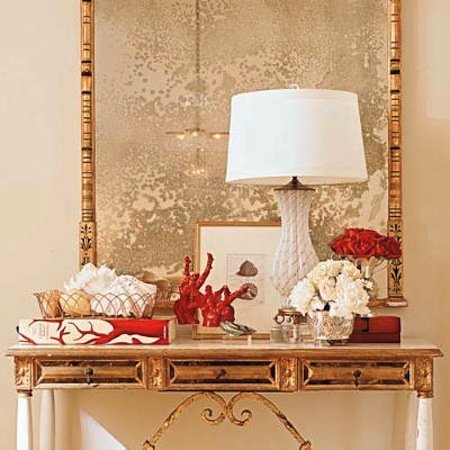White and gold serve as the perfect backdrop for red accessories in this elegant vignette.
Source
White and gold serve as the perfect backdrop for red accessories in this elegant vignette.
Source
