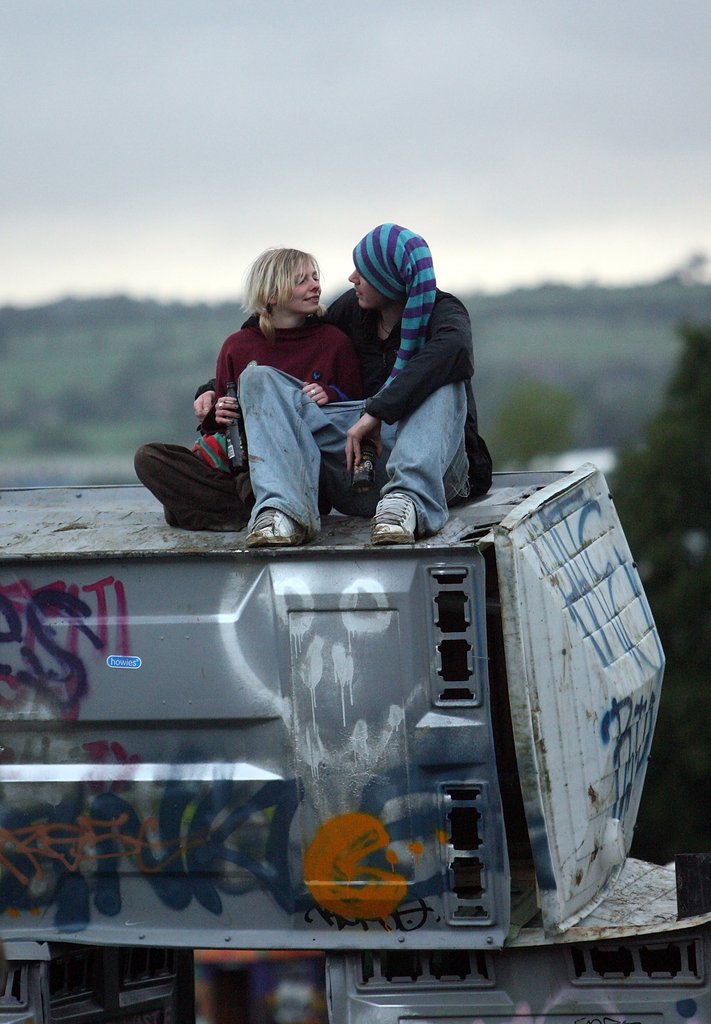 This couple chatted together on top of the Banksy installation during Glastonbury in Somerset, England.
This couple chatted together on top of the Banksy installation during Glastonbury in Somerset, England.