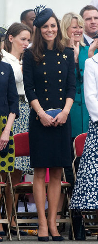 She channeled a military vibe in this navy buttoned-up Alexander McQueen dress and matching navy blue fascinator.
She channeled a military vibe in this navy buttoned-up Alexander McQueen dress and matching navy blue fascinator.