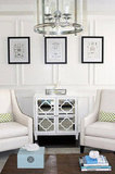 AM Dolce Vita, Living Room, full wall wainscoting, blue silk drapes, curved-arm fabric chairs, framed antique architectural prin
