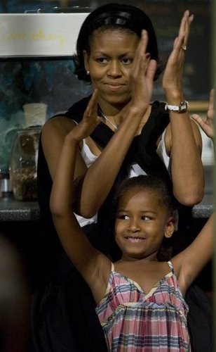 Michelle and Sasha, then 6, listened to Barack give a speech at Smokey Row Coffee in Iowa in 2007.
Michelle and Sasha, then 6, listened to Barack give a speech at Smokey Row Coffee in Iowa in 2007.
