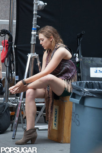Elizabeth Olsen checked her feet on set.
Elizabeth Olsen checked her feet on set.