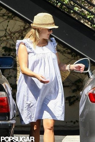 Reese Witherspoon covered up in a hat.
Reese Witherspoon covered up in a hat.