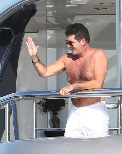 Simon Cowell greeted someone from his yacht.
Simon Cowell greeted someone from his yacht.