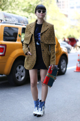 A printed coat, quirky boots, and a colorblocked clutch set this look apart.
A printed coat, quirky boots, and a colorblocked clutch set this look apart.