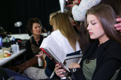 While getting her hair done, this model read backstage at Richard Chai's Fall 2005 show.
While getting her hair done, this model read backstage at Richard Chai's Fall 2005 show.