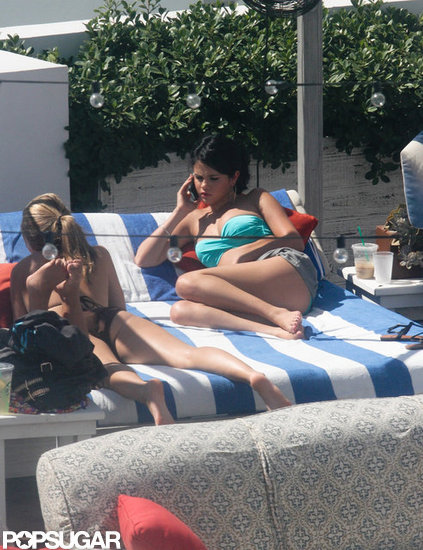 Selena Gomez lounged by the pool in Miami. Selena Gomez lounged by the pool in Miami.