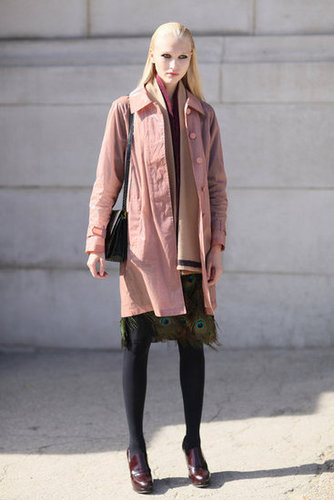 This model showed off her quirky personal styling off the runway, revealing a peacock feather-adorned skirt and a pastel pink coat to contrast her burgundy boots.
This model showed off her quirky personal styling off the runway, revealing a peacock feather-adorned skirt and a pastel pink coat to contrast her burgundy boots.