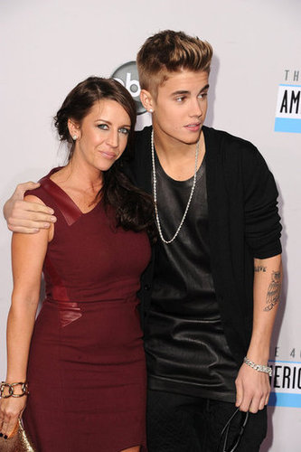 Justin Bieber had his arm around his mom.
Justin Bieber had his arm around his mom.