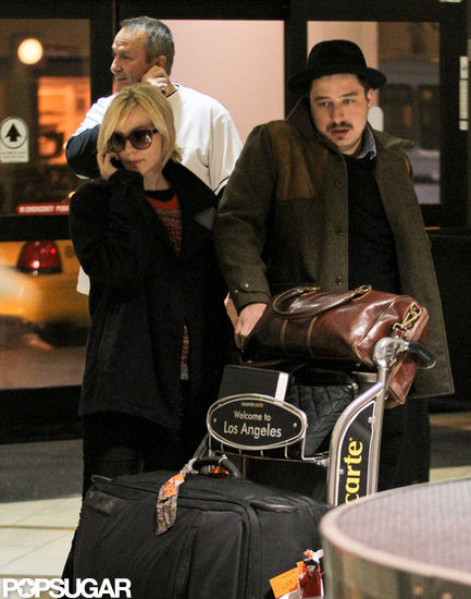 Carey Mulligan and husband Marcus Mumford pushed their bags through the airport. Carey Mulligan and husband Marcus Mumford pushed their bags through the airport.