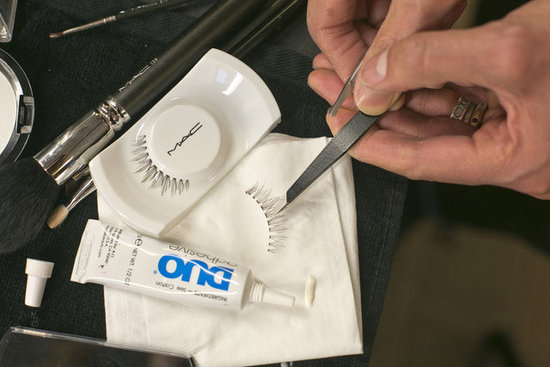 Before you glue the lashes, it's important to get an idea of placement by doing a test on your lids. Once you know where you want to place the lash, trim any edges to make the false lashes fit the base of the eyelid.
Before you glue the lashes, it's important to get an idea of placement by doing a test on your lids. Once you know where you want to place the lash, trim any edges to make the false lashes fit the base of the eyelid.