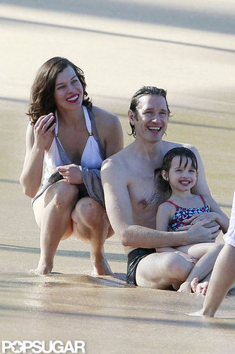Bikini-Clad Milla Jovovich Poses Beachside With Her Family on NYE Bikini-Clad Milla Jovovich Poses Beachside With Her Family on NYE