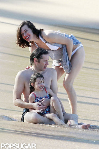 Bikini-Clad Milla Jovovich Poses Beachside With Her Family on NYE Bikini-Clad Milla Jovovich Poses Beachside With Her Family on NYE