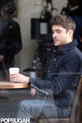 Zac Efron sat in a coffee shop on set.
Zac Efron sat in a coffee shop on set.