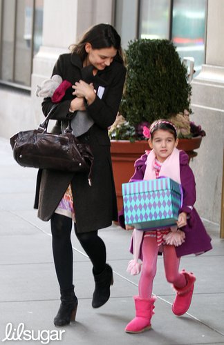 Katie Holmes and daughter Suri left their NYC apartment carrying presents.
Katie Holmes and daughter Suri left their NYC apartment carrying presents.