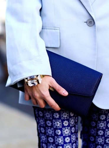 A structured dark blue clutch complements the cool water hues on this sleek outfit.
A structured dark blue clutch complements the cool water hues on this sleek outfit.