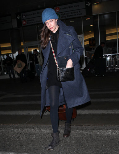 Liv Tyler bundled up in a navy coat and blue ribbed beanie while catching a flight out of LA.
Liv Tyler bundled up in a navy coat and blue ribbed beanie while catching a flight out of LA.