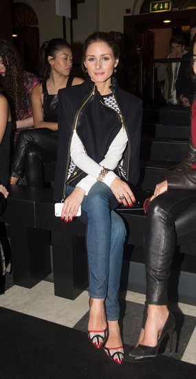 Olivia Palermo layered up in a geometric-print sweater, dual-zipper cape, and red printed pumps while sitting front row at Sass & Bide.
Olivia Palermo layered up in a geometric-print sweater, dual-zipper cape, and red printed pumps while sitting front row at Sass & Bide.