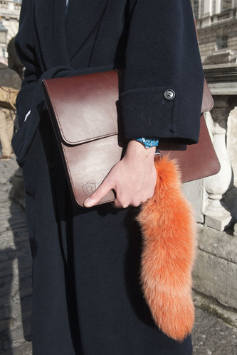 A classic brown portfolio clutch got updated with a furry orange detail.
A classic brown portfolio clutch got updated with a furry orange detail.