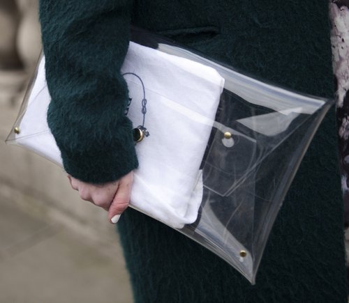 A clear Prada envelope clutch complemented a textural dark-green coat.
A clear Prada envelope clutch complemented a textural dark-green coat.