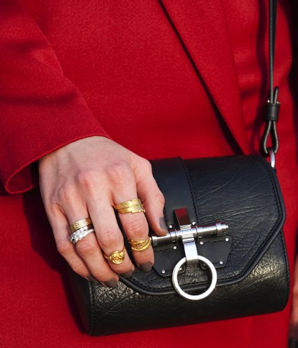 Stacked rings and a sleek mini messenger contrasted against a bright red jacket.
Stacked rings and a sleek mini messenger contrasted against a bright red jacket.