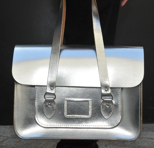 A metallic Cambridge Satchel Company bag stood out amongst dark accompaniments.
A metallic Cambridge Satchel Company bag stood out amongst dark accompaniments.