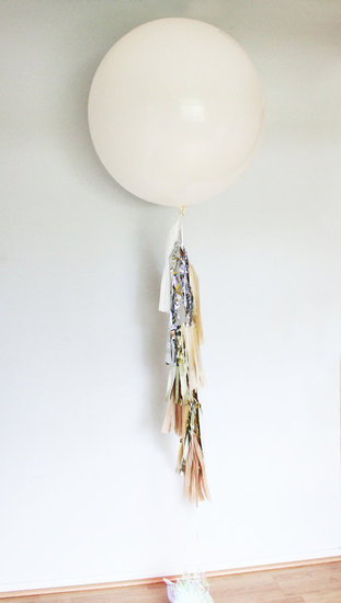 Anchor your bar or buffet with a festive visual, like this oversize tassel balloon ($27).
Anchor your bar or buffet with a festive visual, like this oversize tassel balloon ($27).