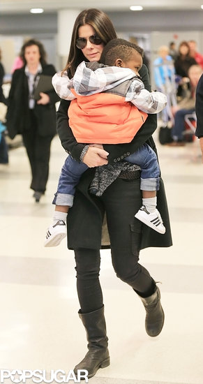 Sandra Bullock carried Louis through the airport.
Sandra Bullock carried Louis through the airport.