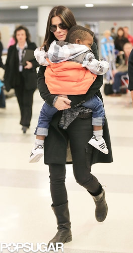 Sandra Bullock carried Louis through the airport.
Sandra Bullock carried Louis through the airport.