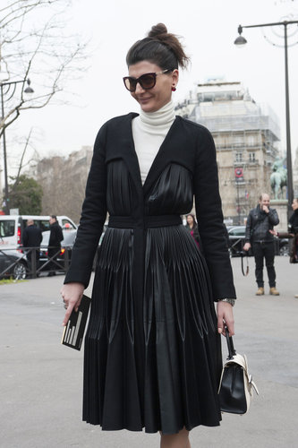 Giovanna Battaglia put her own spin on the classics in a pleated black coat and creamy white turtleneck.
Giovanna Battaglia put her own spin on the classics in a pleated black coat and creamy white turtleneck.