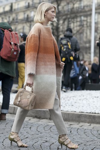 Elena Perminova showed off faded stripes on a luxe furry topper, then finished with strappy heels that played off the muted palette.
Elena Perminova showed off faded stripes on a luxe furry topper, then finished with strappy heels that played off the muted palette.