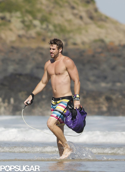 Liam Hemsworth hit the beach shirtless. Liam Hemsworth hit the beach shirtless.