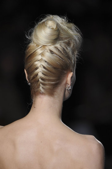 This inverted French braid, spotted at Badgley Mischka, flows up into a crown-level bun. Think of it as an adult twist on two classic styles.
This inverted French braid, spotted at Badgley Mischka, flows up into a crown-level bun. Think of it as an adult twist on two classic styles.