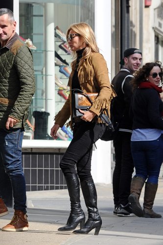 Kate Moss added flair and color to her black London ensemble via a tan suede fringe Saint Laurent jacket and a matching snakeskin bag.
Kate Moss added flair and color to her black London ensemble via a tan suede fringe Saint Laurent jacket and a matching snakeskin bag.