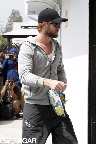 Liam Hemsworth carried his shoes into the gym.
Liam Hemsworth carried his shoes into the gym.