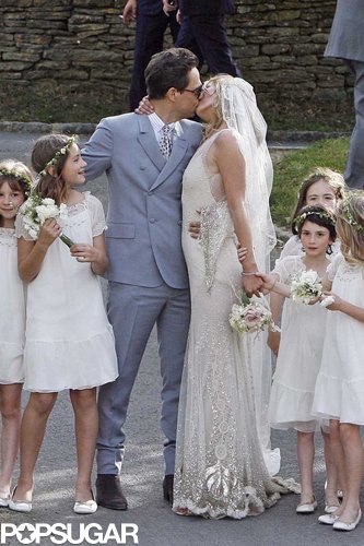 Jamie Hince and supermodel Kate Moss, wearing John Galliano, posed for a kiss following their July 2011 wedding ceremony in England.
Jamie Hince and supermodel Kate Moss, wearing John Galliano, posed for a kiss following their July 2011 wedding ceremony in England.