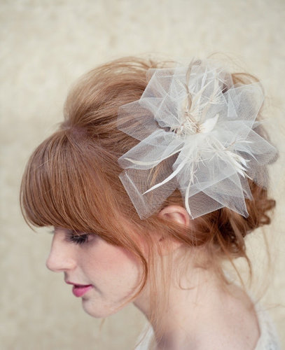 We love the soft tulle pleats on this LoBoheme bridal fascinator ($128).
We love the soft tulle pleats on this LoBoheme bridal fascinator ($128).