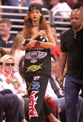 At a Lakers game in April, Rihanna showed off a funky-slash-sporty style, finished with a equally bold accessories: a black baseball cap, a striped clutch, and chunky jewels.
At a Lakers game in April, Rihanna showed off a funky-slash-sporty style, finished with a equally bold accessories: a black baseball cap, a striped clutch, and chunky jewels.
