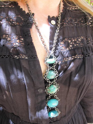 We adore the length of this brushed metal and turquoise stone necklace that's totally a wearable piece of art.
We adore the length of this brushed metal and turquoise stone necklace that's totally a wearable piece of art.