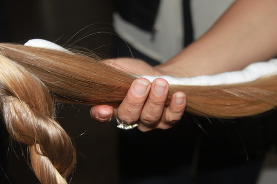 Kérastase lead stylist Akemi Tamaribuchi began by sectioning out the bangs, and piling the remainder of the hair into a midheight ponytail. She used Double Force finishing spray ($39) to slick back the sides, followed by a blast of heat to lock in hold.
Then, she divided the ponytail into two sections using Mousse Substantive ($42) and Elixir Ultime ($54) to add shine before twisting models' strands into loose ropes.
Kérastase lead stylist Akemi Tamaribuchi began by sectioning out the bangs, and piling the remainder of the hair into a midheight ponytail. She used Double Force finishing spray ($39) to slick back the sides, followed by a blast of heat to lock in hold.
Then, she divided the ponytail into two sections using Mousse Substantive ($42) and Elixir Ultime ($54) to add shine before twisting models' strands into loose ropes.