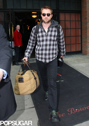 Robert Pattinson carried his luggage out of his hotel after a short stay in the Big Apple.
Robert Pattinson carried his luggage out of his hotel after a short stay in the Big Apple.