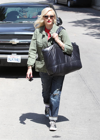 Gwen Stefani exuded boyish appeal in her army jacket, which she paired up with ripped boyfriend jeans, a red tee, Converse sneakers, a black plastic Chanel tote bag, and clear sunglasses in LA.
Gwen Stefani exuded boyish appeal in her army jacket, which she paired up with ripped boyfriend jeans, a red tee, Converse sneakers, a black plastic Chanel tote bag, and clear sunglasses in LA.