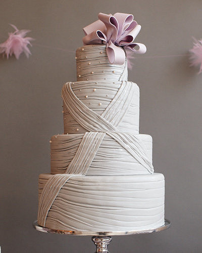 This cake combines both classic and modern elements with etched gray fondant, simple detail, and a modern bow to top it off.
Photo by Johnny Miller via Style Me Pretty
This cake combines both classic and modern elements with etched gray fondant, simple detail, and a modern bow to top it off.
Photo by Johnny Miller via Style Me Pretty