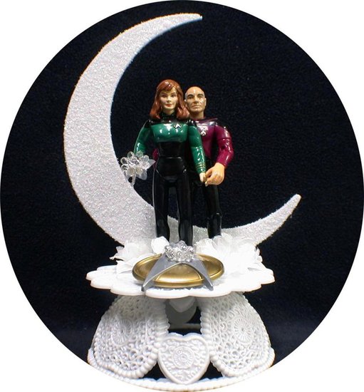 Captain Picard and Dr. Beverly Crusher show their love is out of this world with this white moon-shaped wedding cake topper ($66).
Captain Picard and Dr. Beverly Crusher show their love is out of this world with this white moon-shaped wedding cake topper ($66).
